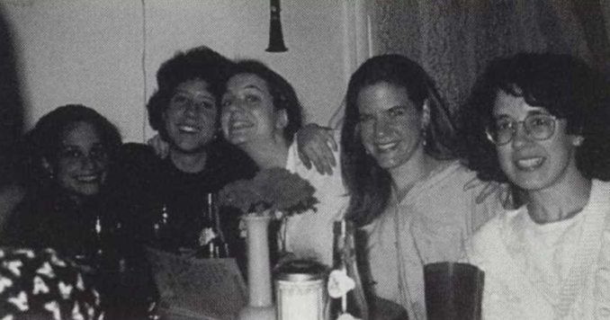Black and white photograph of five women smiling