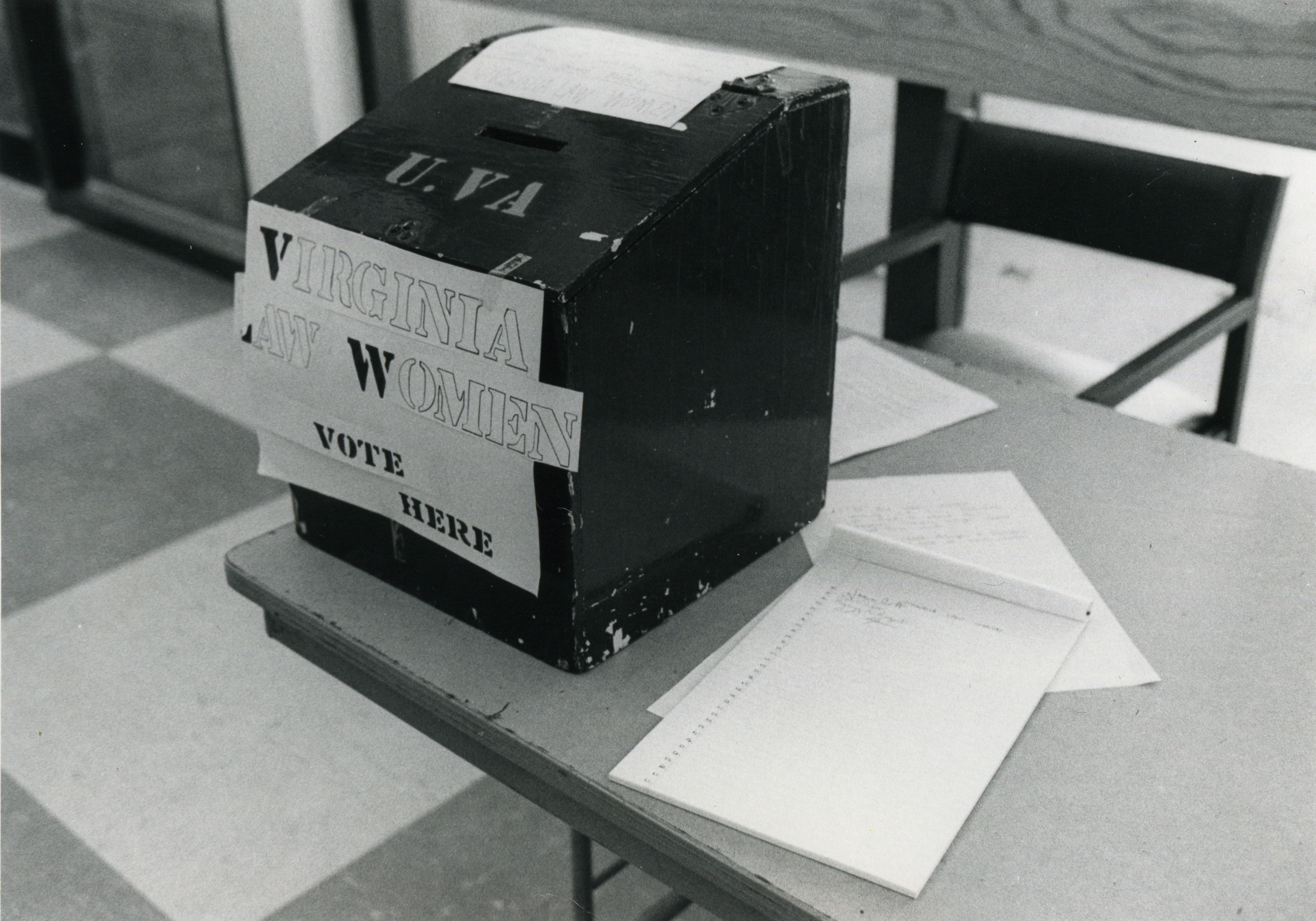 Black and white photograph of ballot box which reads "Virginia Law Women: Vote Here"
