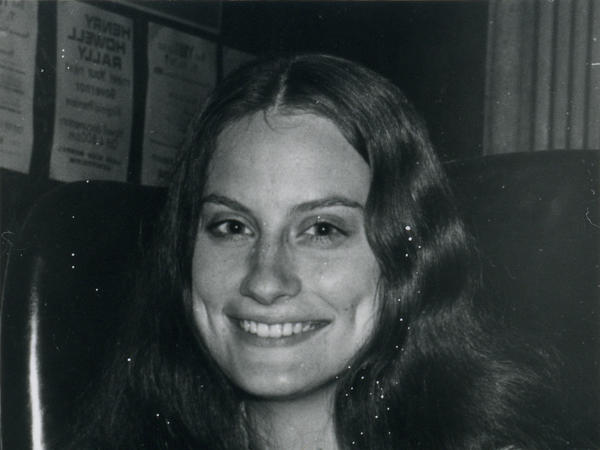 Black and white photograph of a woman smiling