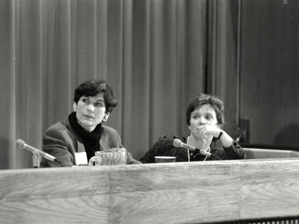 Black and white photograph of two women on a panel