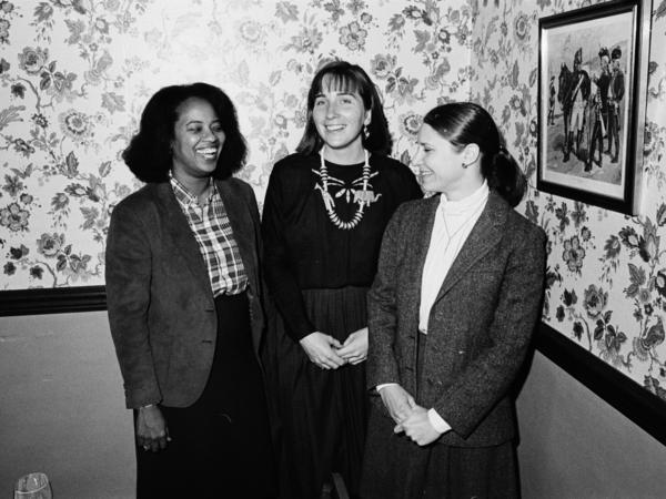 Black and white photo of three women smiling