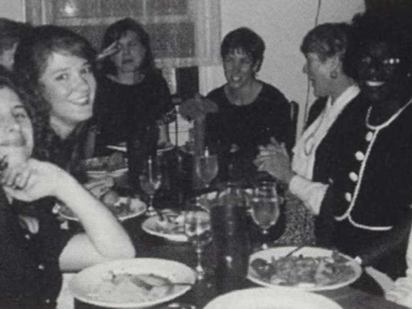 Black and white photograph of group smiling at restaurant