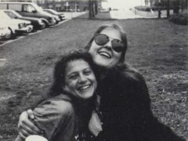 Black and white photograph of two women hugging