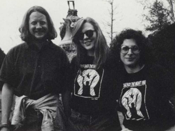Black and white photograph of three women smiling