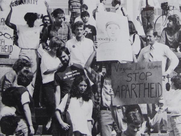 Black and white photograph of UVA students holding protest signs